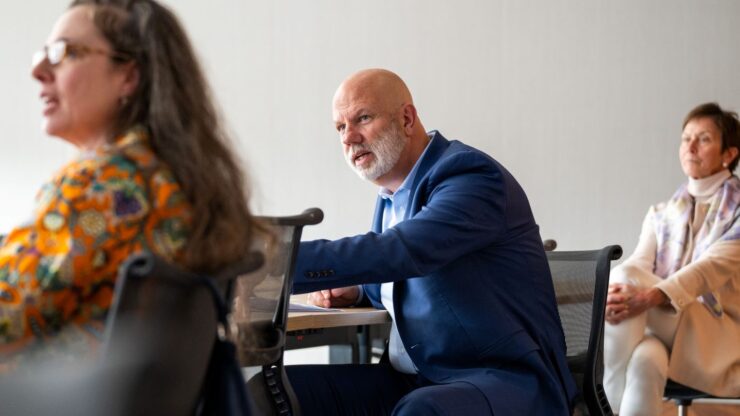 Three industry partners seated and engaging